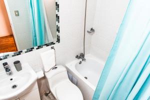 a bathroom with a toilet and a sink and a tub at Hostal Tulvak Atacama in San Pedro de Atacama