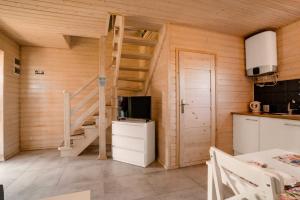 a room with a staircase in a wooden house at Havana Sarbinowo in Sarbinowo