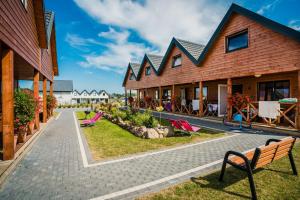 a row of houses with chairs in front of them at Havana Sarbinowo in Sarbinowo
