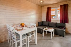 a living room with a couch and a table at Havana Sarbinowo in Sarbinowo +19 photos