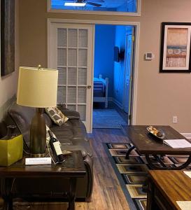 a living room with a couch and a table with a lamp at Turner's loft / sleeps 4 in the heart of the town in Wilmington