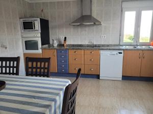 a kitchen with a table and a stove top oven at La Tablada in Recuevo +9 photos