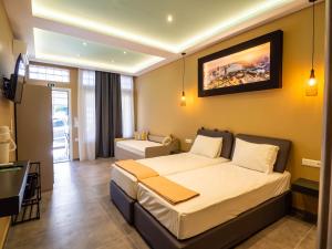 a hotel room with a large bed in a room at ThassCities Casa Studios in Limenas