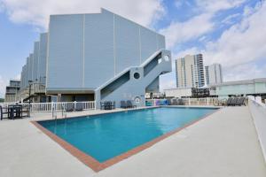 a swimming pool with a slide in front of a building at Summer House West B103 in Gulf Shores