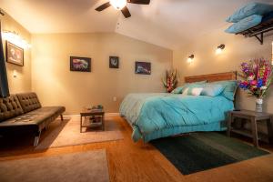 a bedroom with a large bed and a couch at talkeetna villas and tours in Talkeetna