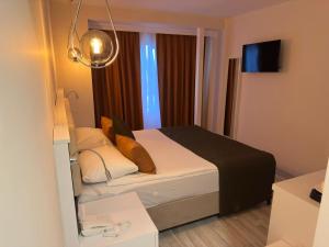 Postel nebo postele na pokoji v ubytování Aura Boutique Hotel