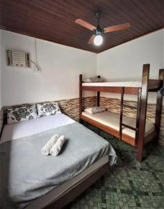 a bedroom with two bunk beds and a ceiling fan at Ilha Grande Inn in Abraão
