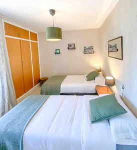 a hotel room with two beds and a room with two beds at Casa Andorrana - ¡A Pie de todo! in Encamp