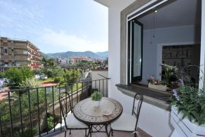 a balcony with a table and chairs and a view at Victor's House in Sant'Agnello