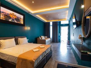 a hotel room with a bed and a couch at ThassCities Casa Studios in Limenas