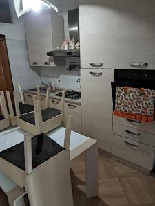 a kitchen with a table and chairs and a stove at Appartamento Grandi in Peschici