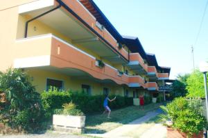 a person walking in front of a building at Residence Miralago Rooms & Apartments in Manerba del Garda