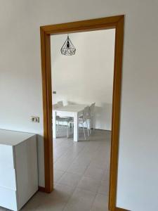 a dining room with a table and a table and a mirror at Terrazza sul lago (CIR 017085-LNI-00027) in Iseo +4 photos
