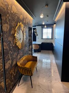 Pokój z krzesłem i lustrem na ścianie w obiekcie Golden Flamingo Apartment w Gdańsku