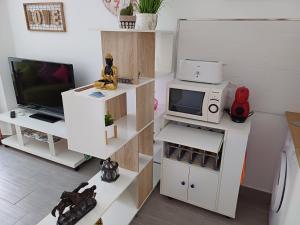 a living room with a tv and a microwave at Estudio El Faro II in Torrox Costa