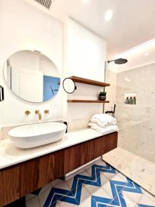 a bathroom with a sink and a mirror at OraBlu Exclusive Villas in Ischia