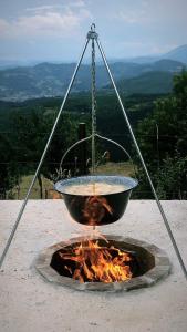 a fountain with a bowl on top of a fire at Seosko domacinstvo Becirovic - Kukulik lodgings in Bijelo Polje