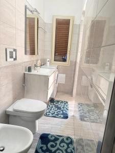 a bathroom with a toilet and a sink and a shower at Casa panorama Sciacca in Sciacca