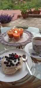a plate with a pastry on a table with a cup of coffee at Agroturystyka Gandelinka Park Kędrzyno in Kędrzyno +19 photos