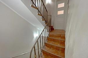 a staircase in a home with white walls and wooden floors at Luxury Apartments Campofelice in Campofelice di Roccella