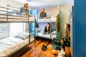 a group of people sitting in a room with bunk beds at Samesun Ocean Beach Hotel & Hostel in San Diego +53 photos