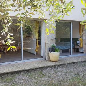 una ventana de una casa con una planta en una olla en Appartement 2 pieces, en Gravières