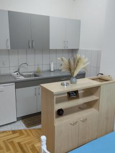 a kitchen with white cabinets and a sink at Apartman (stan na dan) M&M 2 Prijedor in Prijedor