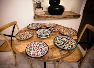 a wooden table with plates on top of it at Templars suite in ‘Akko