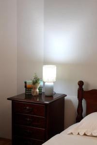 a lamp on a dresser next to a bed at FJAKA - Kuća za odmor - NP Krka in Drniš