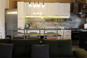 a kitchen with a couch in front of a kitchen counter at FJAKA - Kuća za odmor - NP Krka in Drniš