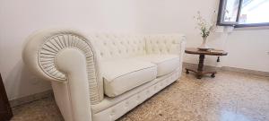 a white couch in a room with a table at C'era una volta, centrale, Parco Velino Sirente in Celano