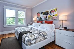 a bedroom with a king sized bed and a dresser at The Home Collection CLT: 800 Magnolia in Charlotte