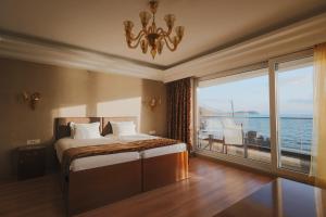 a bedroom with a bed with a view of the ocean at Mr.I Boutique Hotel & Bar in Ohrid