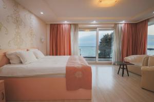 a hotel room with a bed and a large window at Mr.I Boutique Hotel & Bar in Ohrid