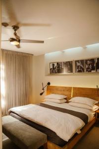 a bedroom with two beds and a ceiling fan at Billini Hotel, Historic Luxury in Santo Domingo