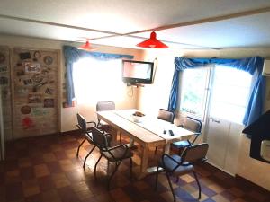 a dining room with a wooden table and chairs at La casita de Manu in Guaymallen