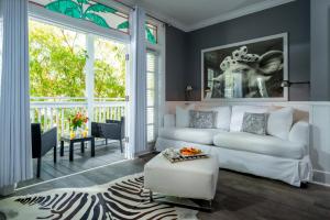 a living room with a white couch and a table at Alexander's Gay Lesbian Guesthouse (Adult Only 21+) in Key West