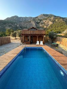 a swimming pool in front of a house at Likya Garden Life in Gâvurağılı