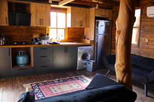 a kitchen with a refrigerator and a stove at Likya Garden Life in Gâvurağılı