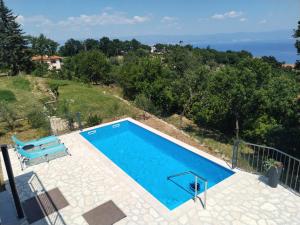 a pool with a view of the ocean from a house at Holiday house Jovich in Martina