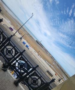 a view of a beach with a plane flying over it at Imperial Suites Heart Of Margate! sleeps 6 in Kent