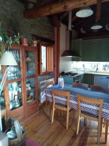 a kitchen with a table and chairs in a room at La Borda de Allué in Huesca