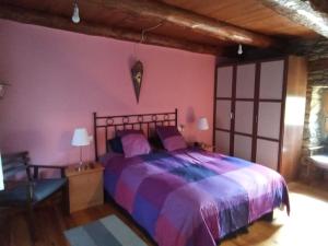 a bedroom with a large bed in a room at La Borda de Allué in Huesca
