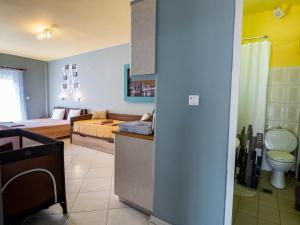 a living room with a bed and a room with a kitchen at ThassCities Casa Studios in Limenas +272 photos