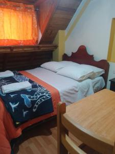 Postel nebo postele na pokoji v ubytování hostal ollantaytambo apartments