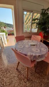 a table and chairs in a room with a patio at Ca La Luci in San Juan de Palamós