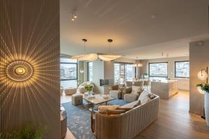 a living room with a couch and a table at Vindlys Luxury Penthouse Apartment in Tromsø