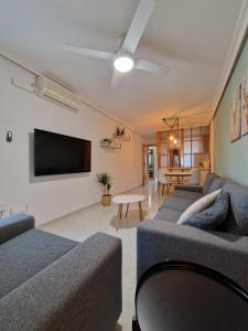 a living room with two couches and a flat screen tv at Casa Bonita in San Pedro del Pinatar