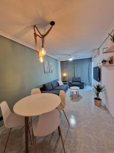 a living room with a table and a couch at Casa Bonita in San Pedro del Pinatar +23 photos