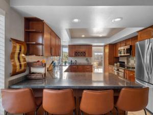 a large kitchen with a large island with bar chairs at Breathtaking views, close to the ocean and canyon in Laguna Niguel